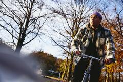 Cycling man, autumn trees on the background.