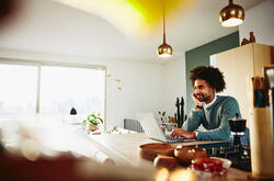 guy using laptop with chin on right hand