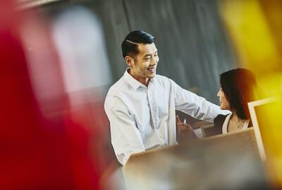 Man and woman talking. China. Primary color: red.