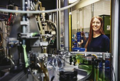 Woman operating a machine on a production site. 