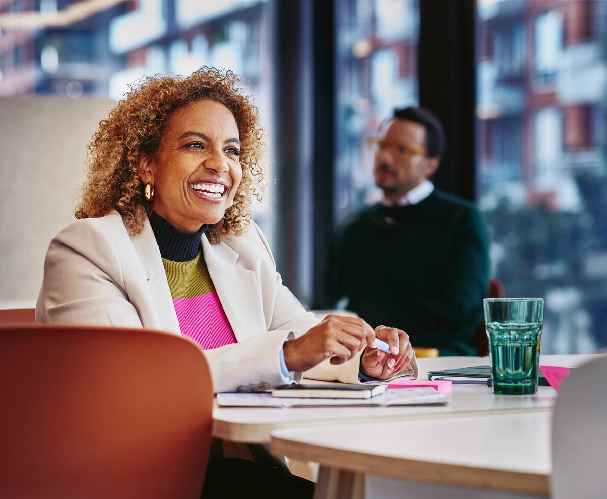 a close up of a woman smiling in a boardroom