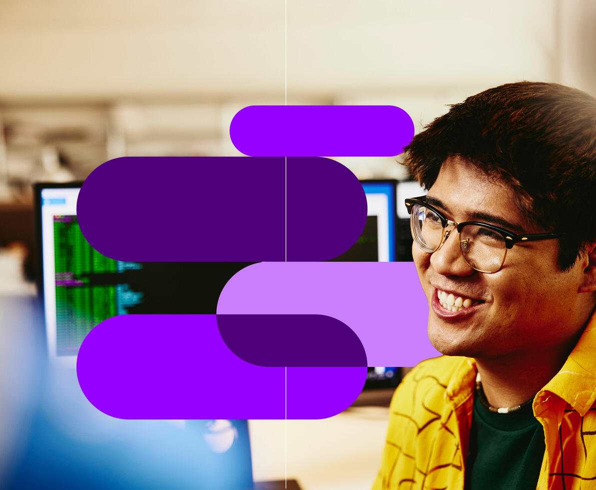 a man smiling working in an office 