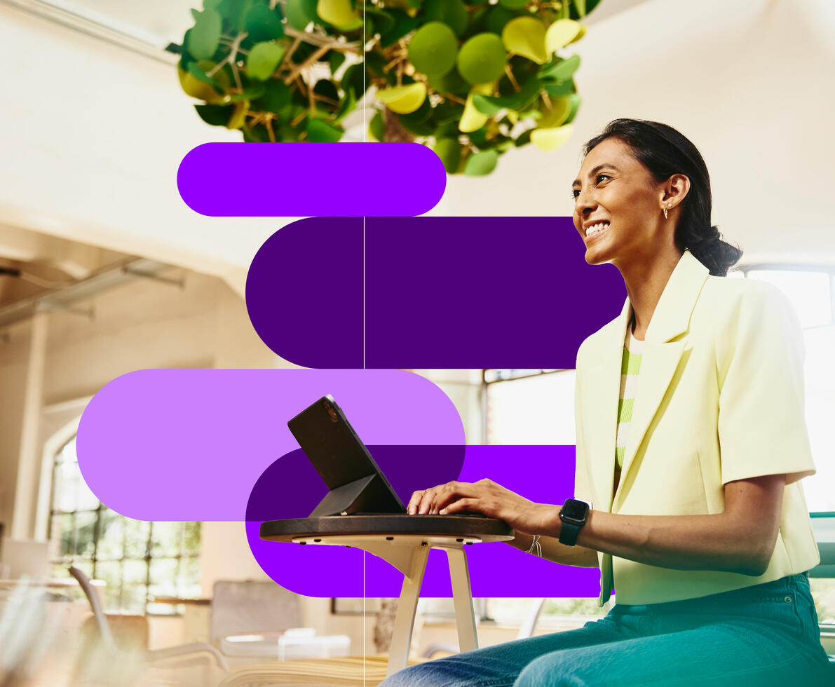 A smiling woman working on a computer