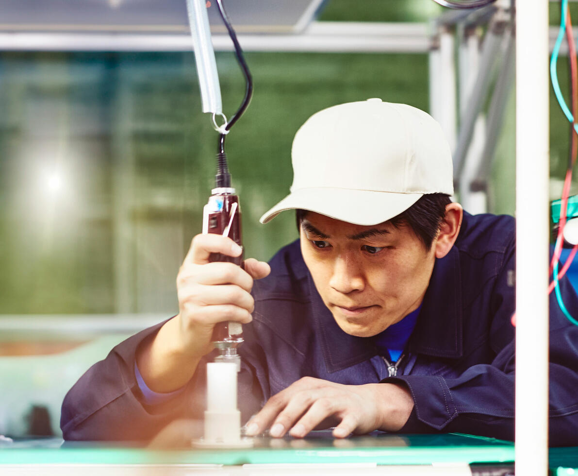 a man working with a tool in a workshop