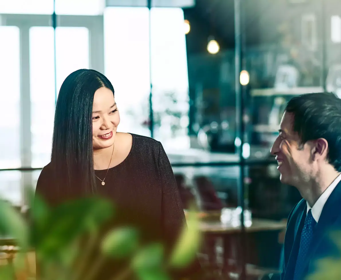 male and female talking and smiling.